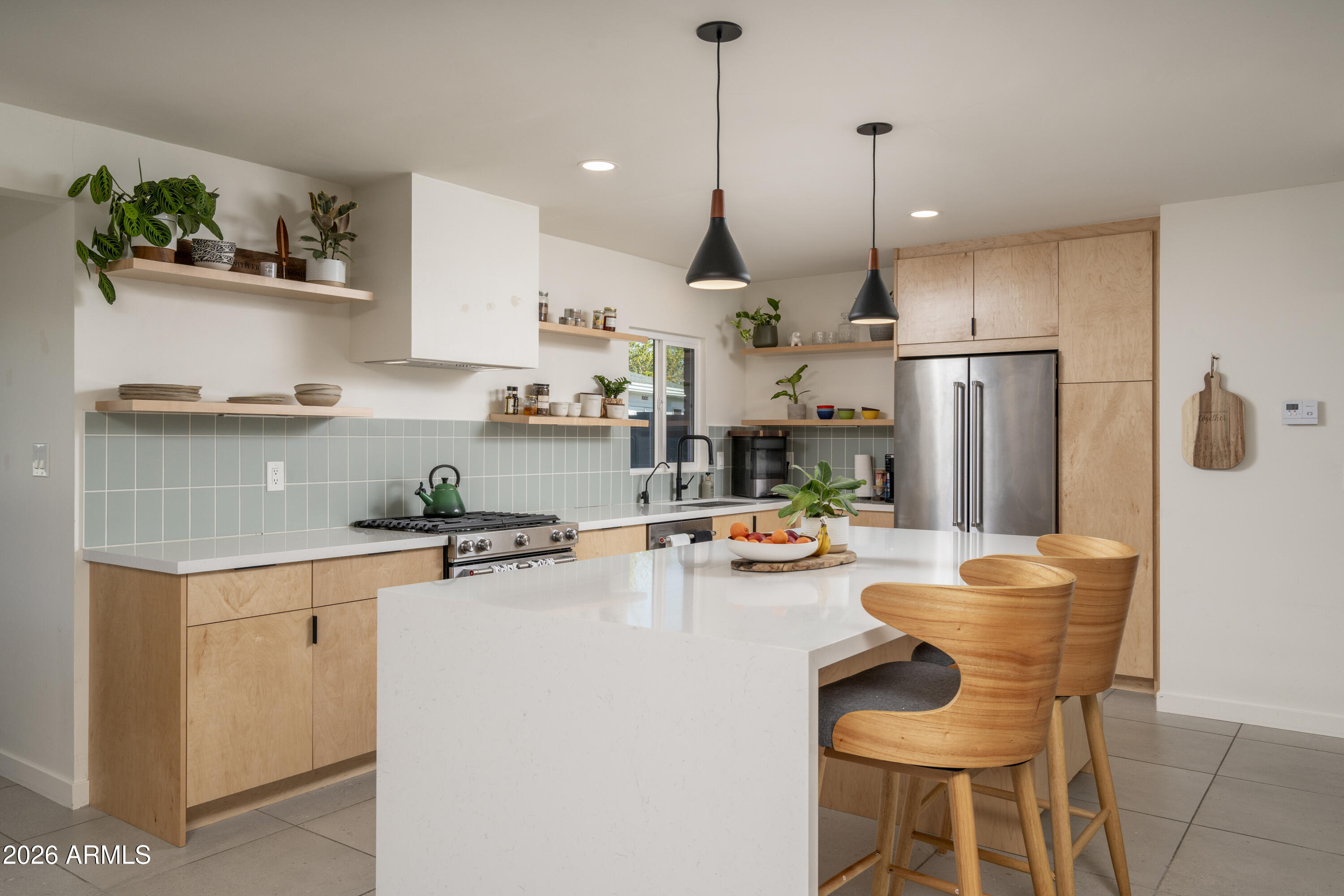 8049 North 10th Street Phoenix, AZ 85020 - Photo 2 of 40 a kitchen with stainless steel appliances granite countertop a sink a stove a refrigerator and chairs