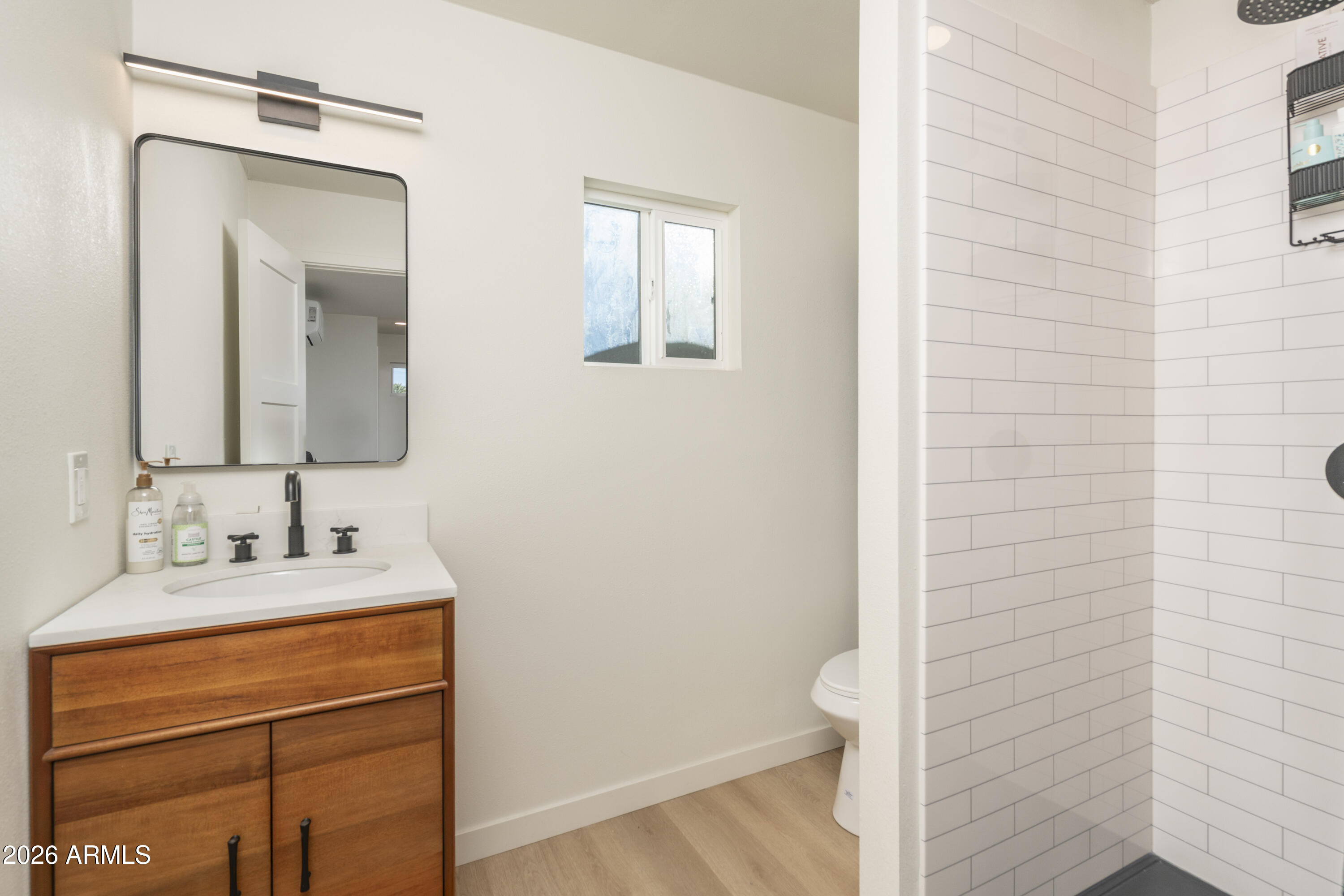 8049 North 10th Street Phoenix, AZ 85020 - Photo 26 of 40 a bathroom with a sink vanity and a mirror