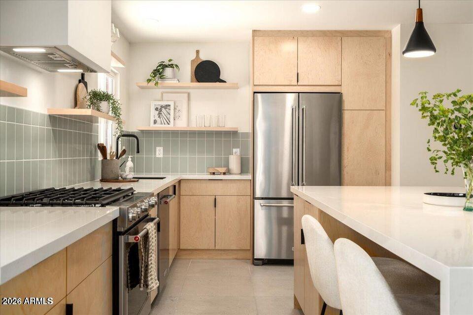 8049 North 10th Street Phoenix, AZ 85020 - Photo 8 of 40 a kitchen with a refrigerator and a sink
