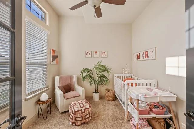 a living room with furniture and paintings on the wall