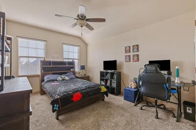 a bedroom with a bed and a desk