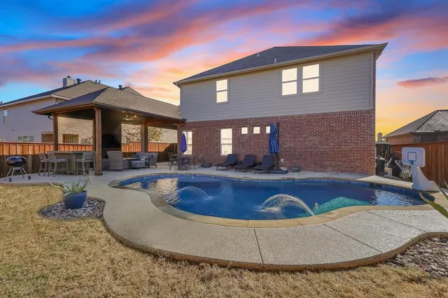a view of a house with swimming pool and sitting area