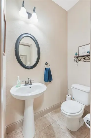 a bathroom with a sink a mirror and toilet