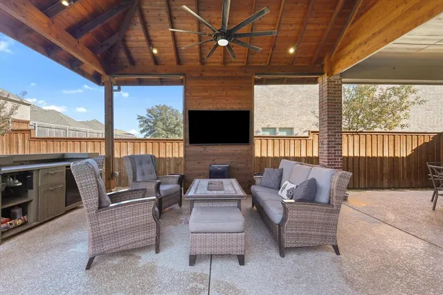 a outdoor living space with furniture and a flat screen tv