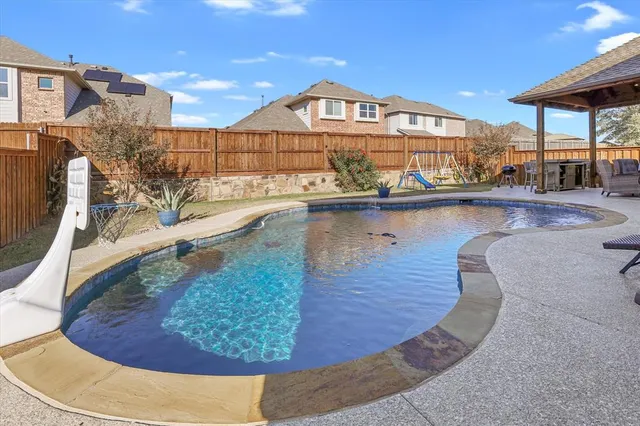 a view of a swimming pool with a bench