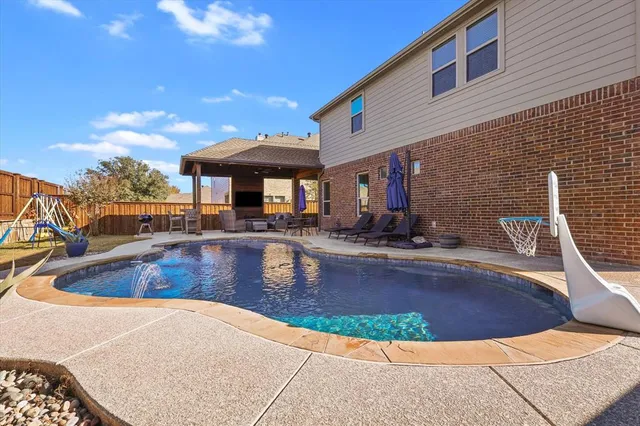 a view of a swimming pool with outdoor seating