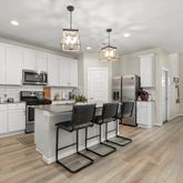 a view of kitchen with sink microwave and cabinets