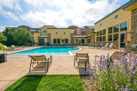 a swimming pool with outdoor seating and yard