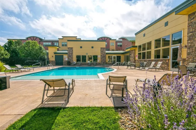 a swimming pool with outdoor seating and yard