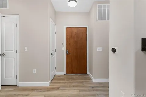 a dining room with furniture and a potted plant