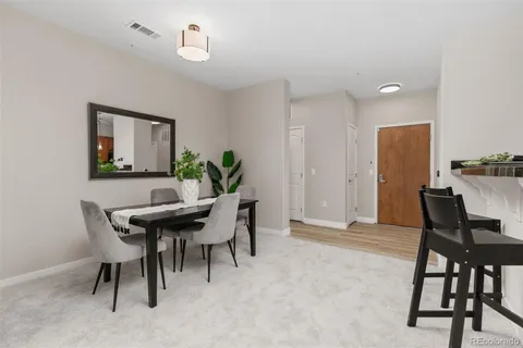 a view of a balcony with a floor to ceiling window and wooden fence