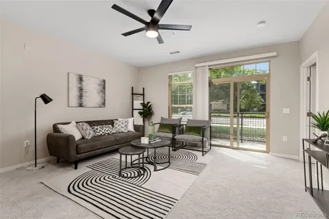 a living room with furniture and a large window