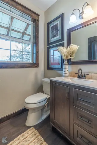 a bathroom with a toilet a sink and a mirror