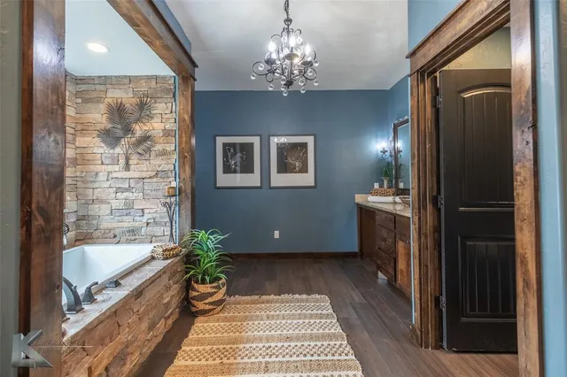 a bathroom with a bathtub a shower and a mirror