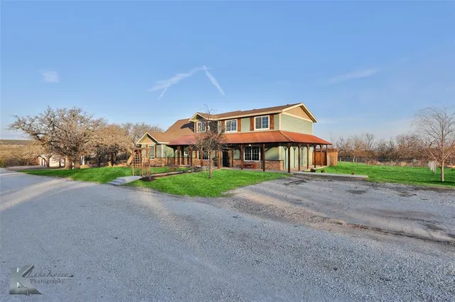 a front view of house with yard and green space