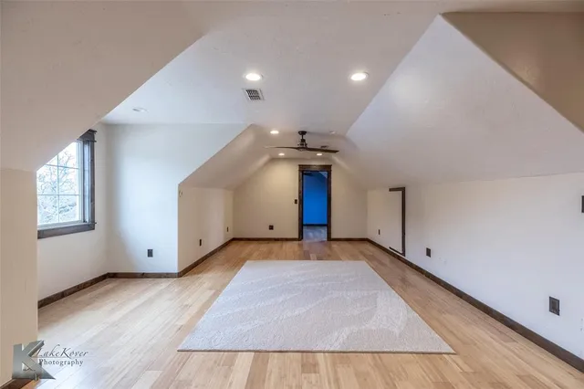 a view of a big room with closet and windows