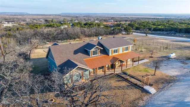 an aerial view of a house with garden space and outdoor seating