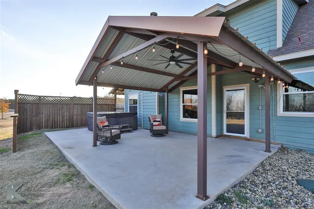 a view of a backyard with sitting area and roof