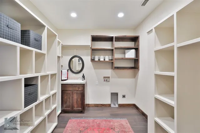 a view of room with cabinets and wooden floor