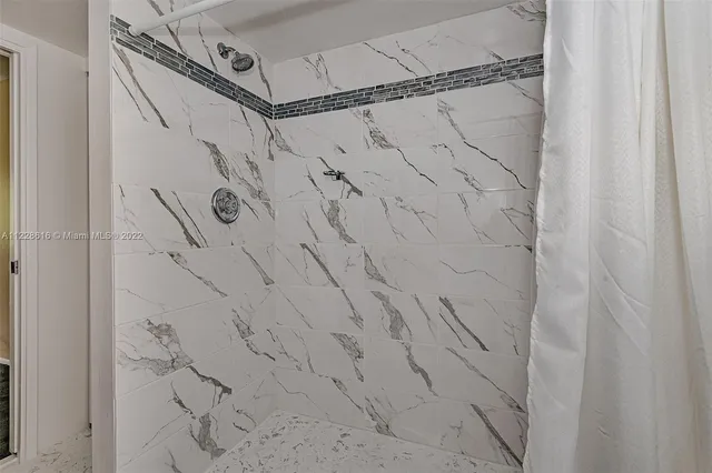 a view of a hallway with a chandelier fan