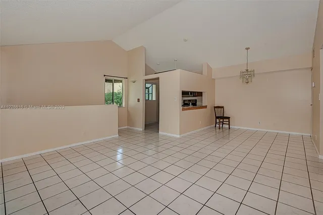 a kitchen with granite countertop a refrigerator and a stove top oven