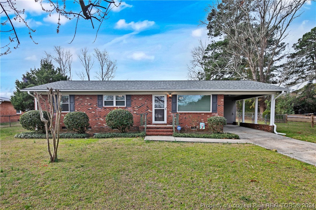 636 Pleasant Loop Fayetteville, NC 28311 - Photo 1 of 40 a front view of house with a garden and patio