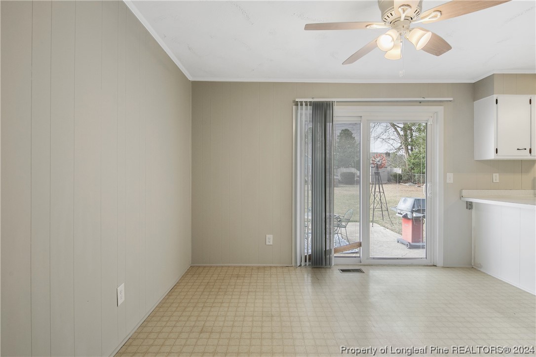 636 Pleasant Loop Fayetteville, NC 28311 - Photo 11 of 40 an empty room with chandelier fan and windows