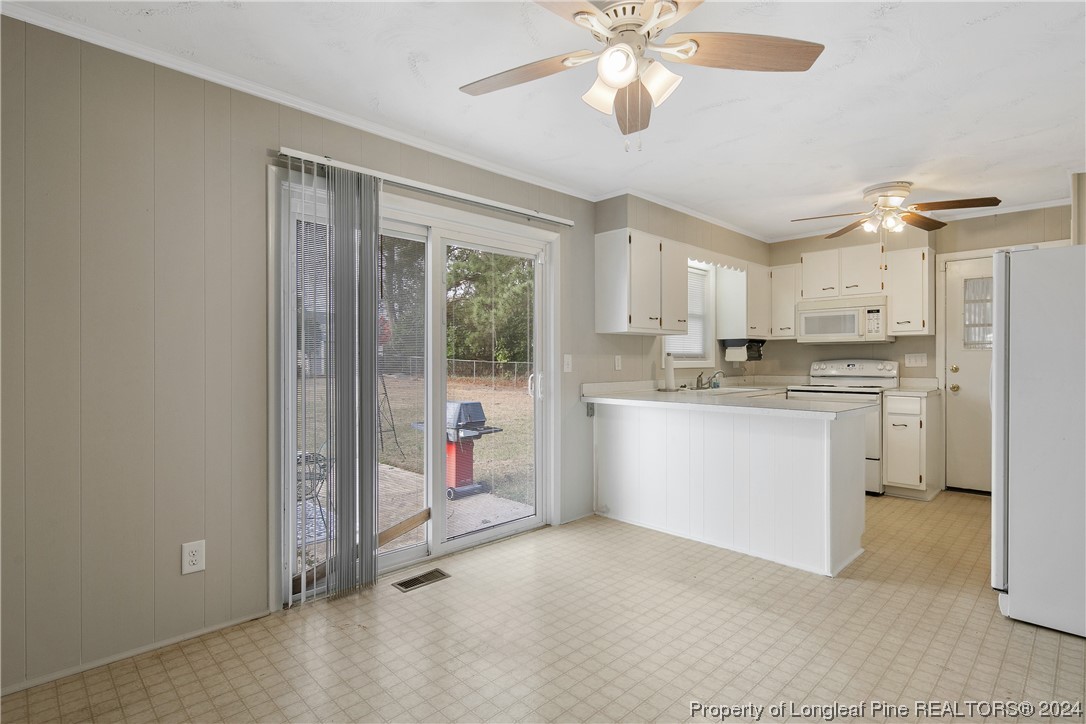 636 Pleasant Loop Fayetteville, NC 28311 - Photo 12 of 40 a kitchen with a refrigerator a sink and cabinets