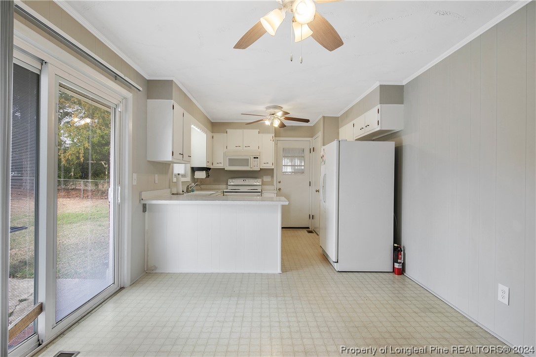 636 Pleasant Loop Fayetteville, NC 28311 - Photo 13 of 40 a view of kitchen with refrigerator and window