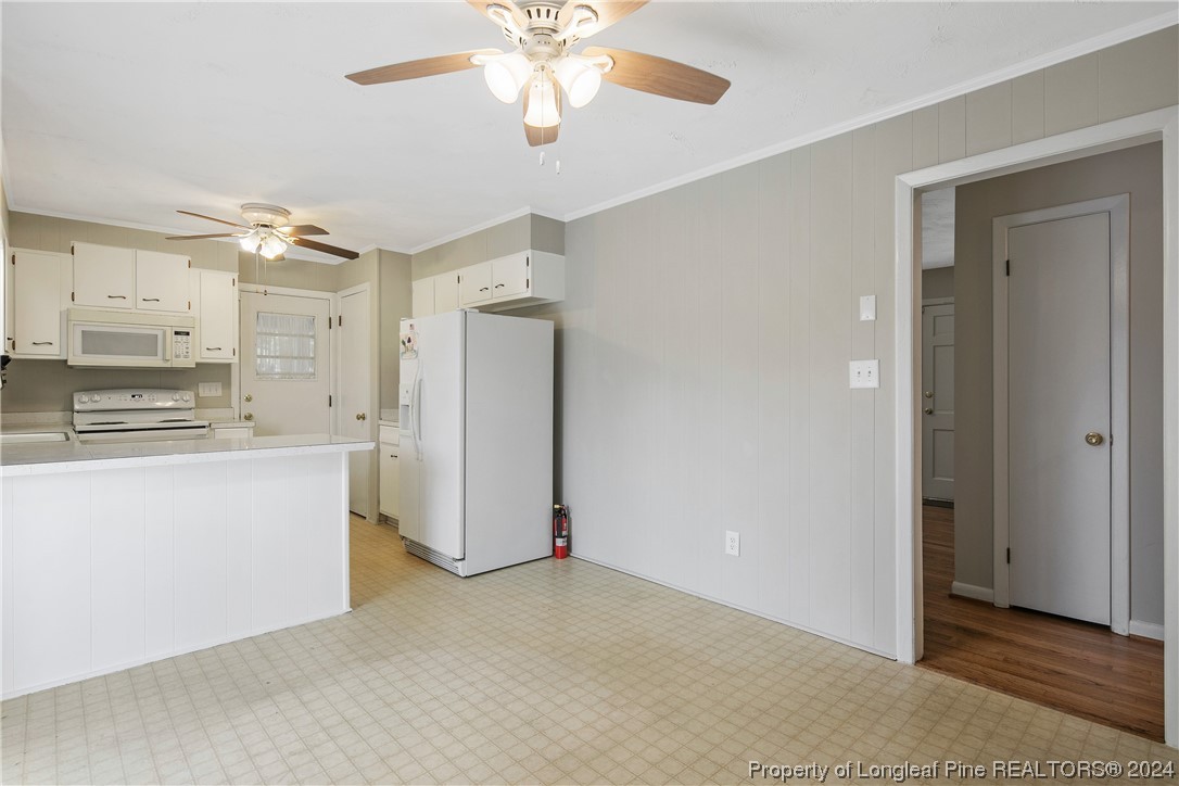 636 Pleasant Loop Fayetteville, NC 28311 - Photo 14 of 40 a view of kitchen with refrigerator cabinets and a ceiling fan