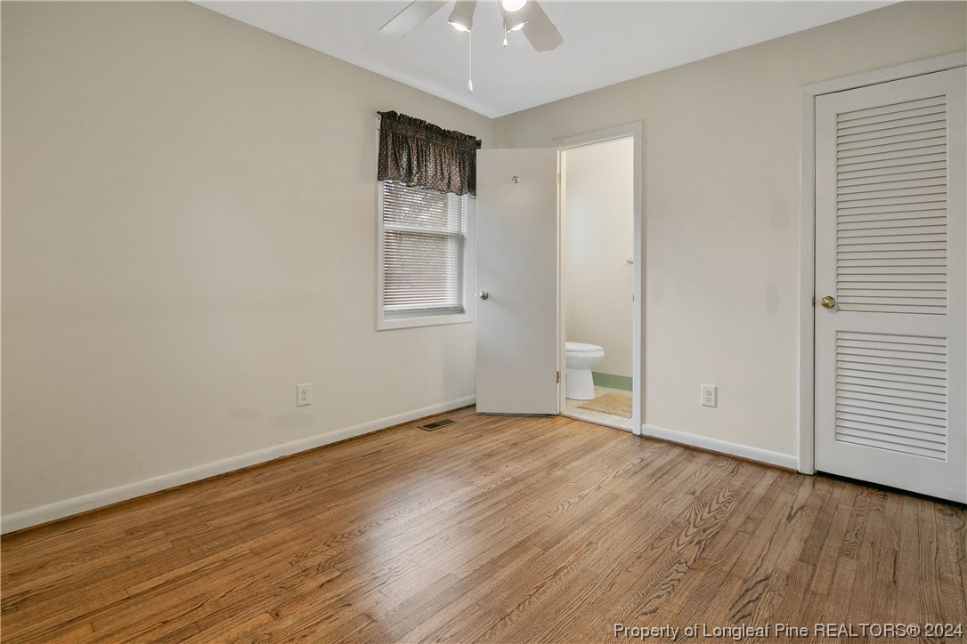636 Pleasant Loop Fayetteville, NC 28311 - Photo 23 of 40 an empty room with wooden floor and windows