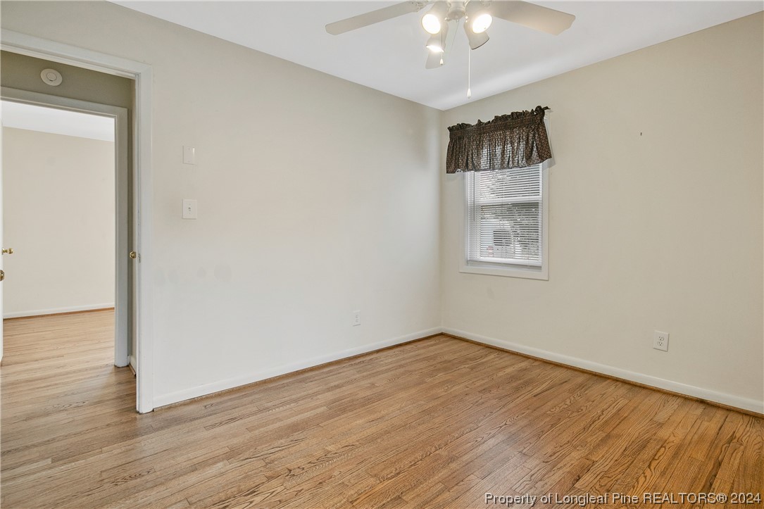 636 Pleasant Loop Fayetteville, NC 28311 - Photo 25 of 40 a view of an empty room with wooden floor and a window