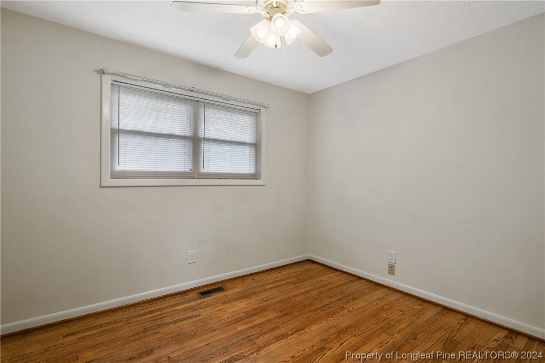 636 Pleasant Loop Fayetteville, NC 28311 - Photo 27 of 40 a view of an empty room with wooden floor and a window