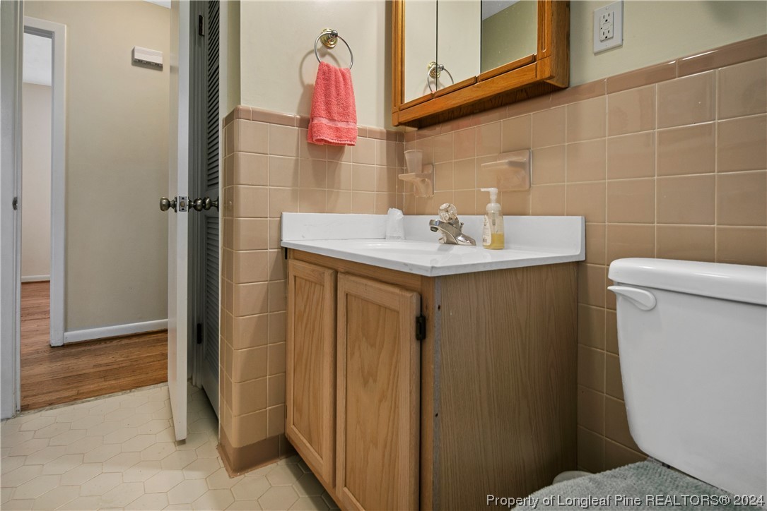 636 Pleasant Loop Fayetteville, NC 28311 - Photo 32 of 40 a bathroom with a sink a toilet and a mirror