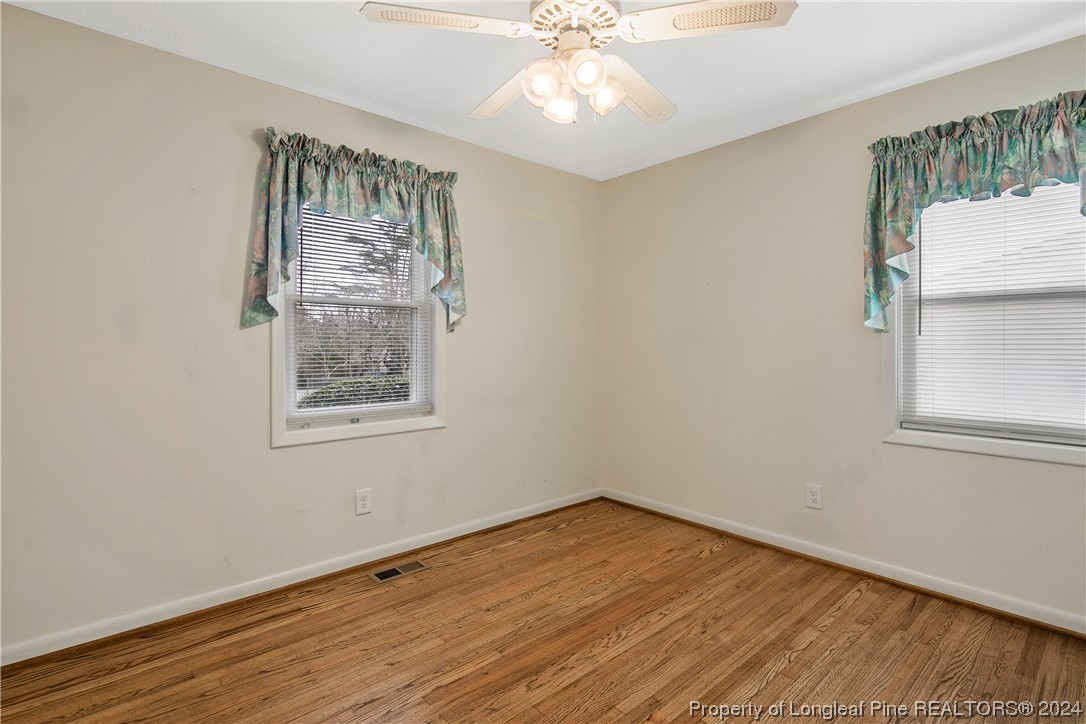 636 Pleasant Loop Fayetteville, NC 28311 - Photo 33 of 40 a view of an empty room with wooden floor and a window