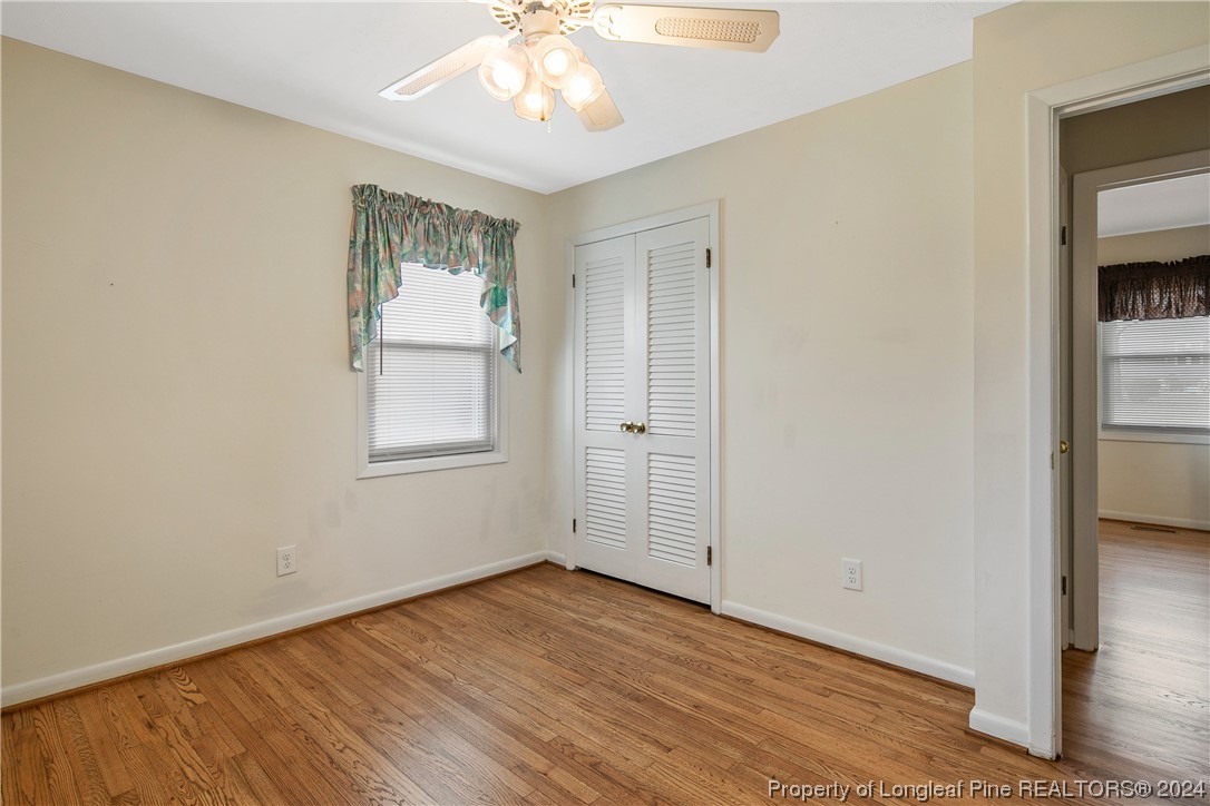 636 Pleasant Loop Fayetteville, NC 28311 - Photo 34 of 40 a view of an empty room with wooden floor and a window