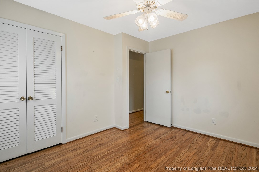 636 Pleasant Loop Fayetteville, NC 28311 - Photo 35 of 40 an empty room with wooden floor closet and windows