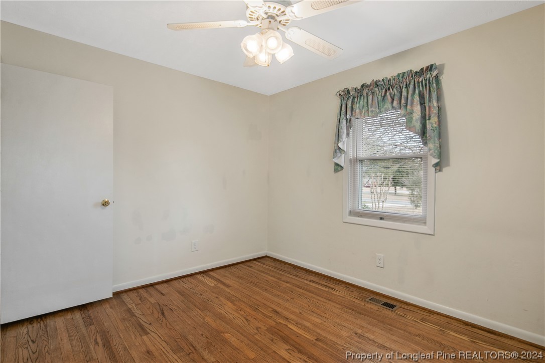 636 Pleasant Loop Fayetteville, NC 28311 - Photo 36 of 40 an empty room with a window and wooden floor