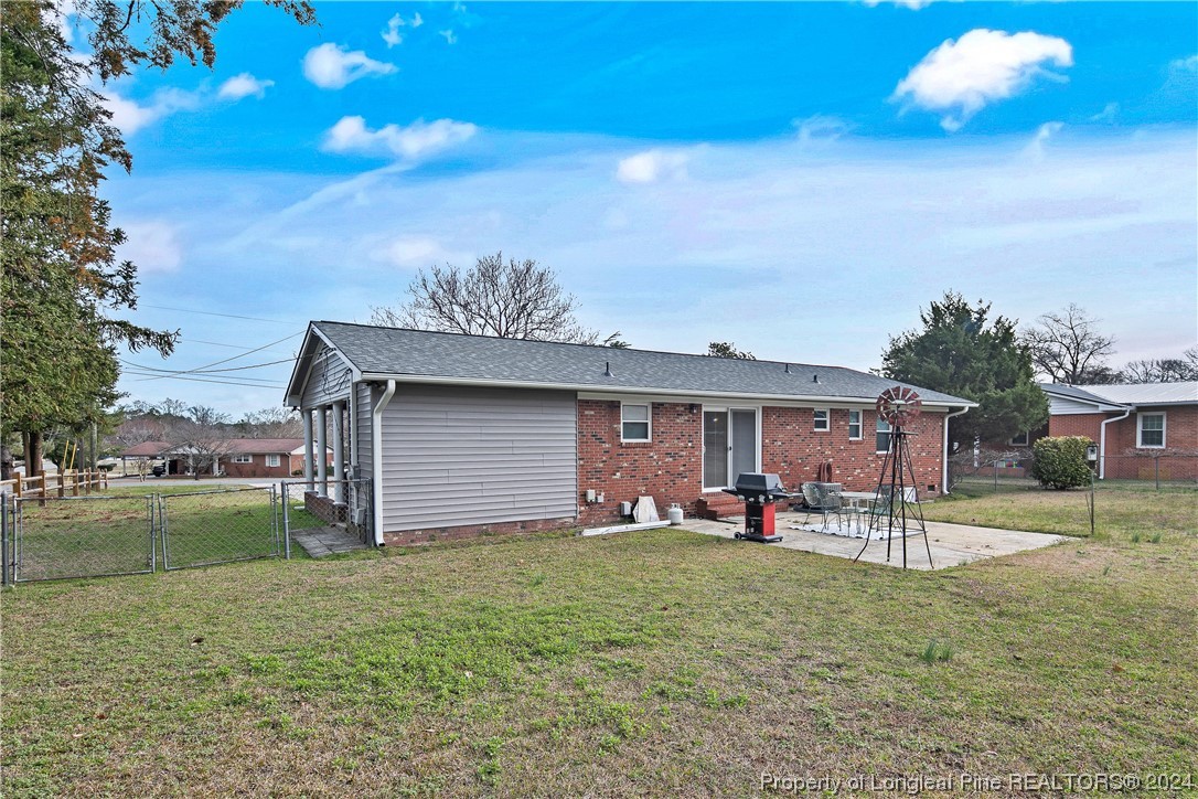 636 Pleasant Loop Fayetteville, NC 28311 - Photo 39 of 40 a house view with a sitting space and garden