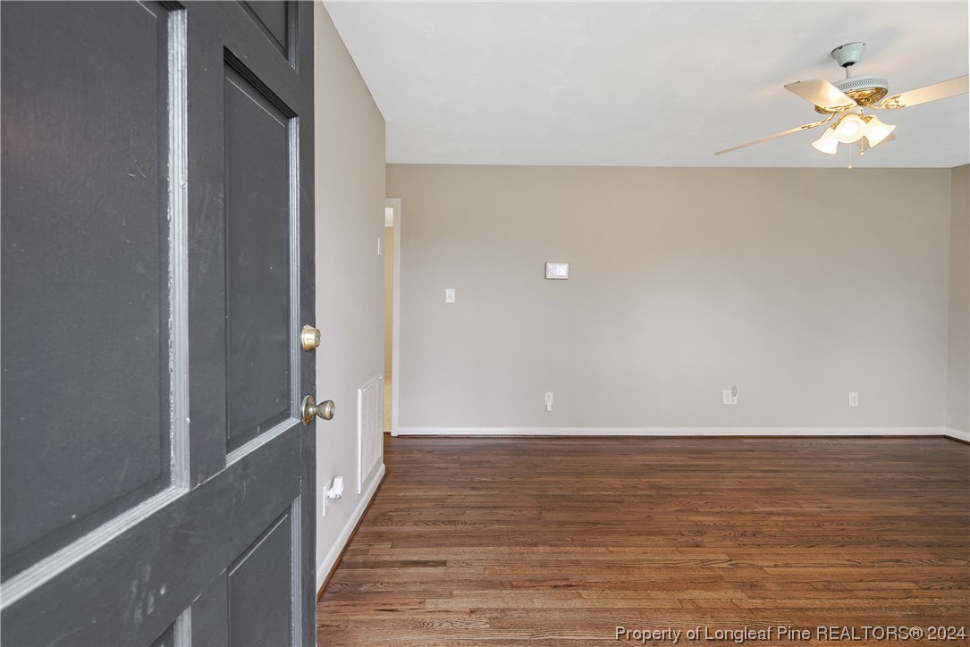 636 Pleasant Loop Fayetteville, NC 28311 - Photo 5 of 40 a view of a room with wooden floor and a chandelier fan