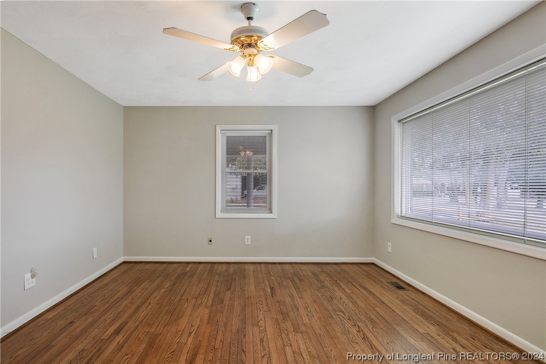 636 Pleasant Loop Fayetteville, NC 28311 - Photo 7 of 40 wooden floor in an empty room with a window