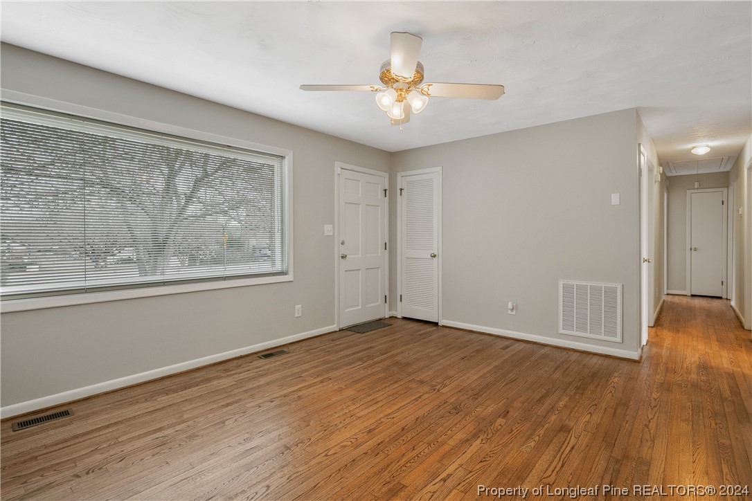 636 Pleasant Loop Fayetteville, NC 28311 - Photo 9 of 40 a view of an empty room with wooden floor and a window
