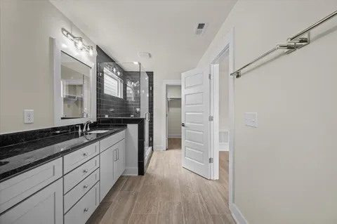 a bathroom with sinks granite countertop a sink and a mirror