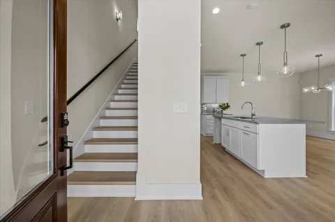 a view of a kitchen with wooden floor and electronic appliances