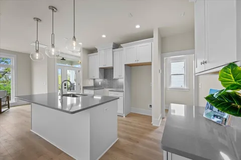 a kitchen with a sink a counter space and stainless steel appliances