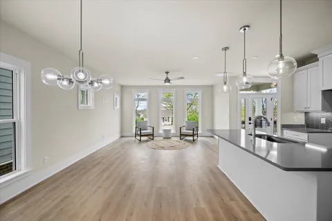 a kitchen with stainless steel appliances granite countertop a stove and a wooden floor