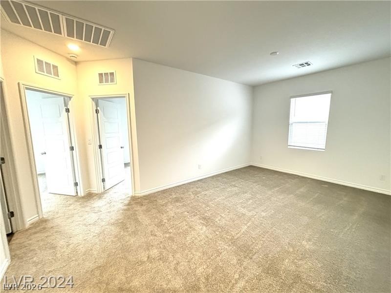 8336 Rowan Rdg Avenue Las Vegas, NV 89147 - Photo 6 of 15 Bright and inviting, this carpeted room offers versatile living space with natural light.
