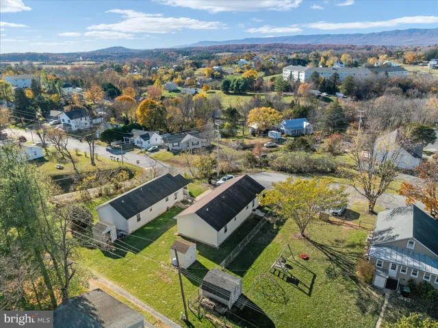 an aerial view of residential houses with outdoor space