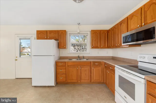 a kitchen with a refrigerator sink and microwave