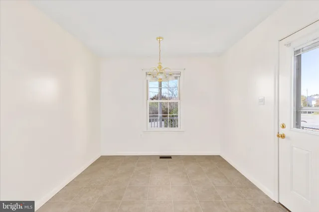 an empty room with windows and entrance